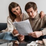 close-up-couple-reading-document_23-2148758152